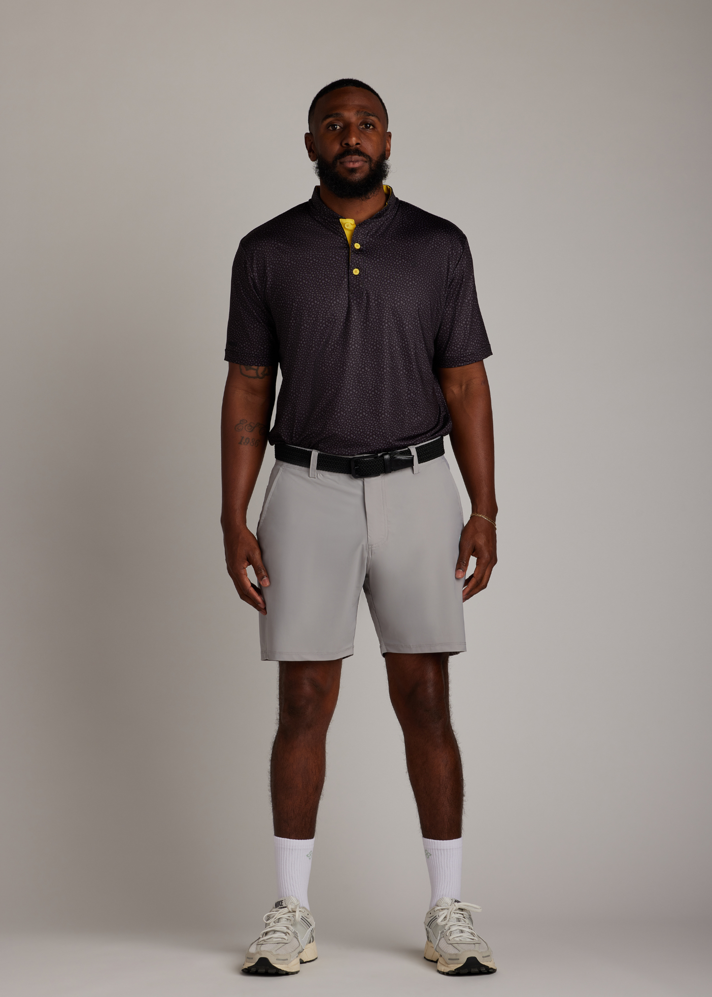 Black knitted belt with a pin buckle, offering durability and flexibility for versatile wear.
