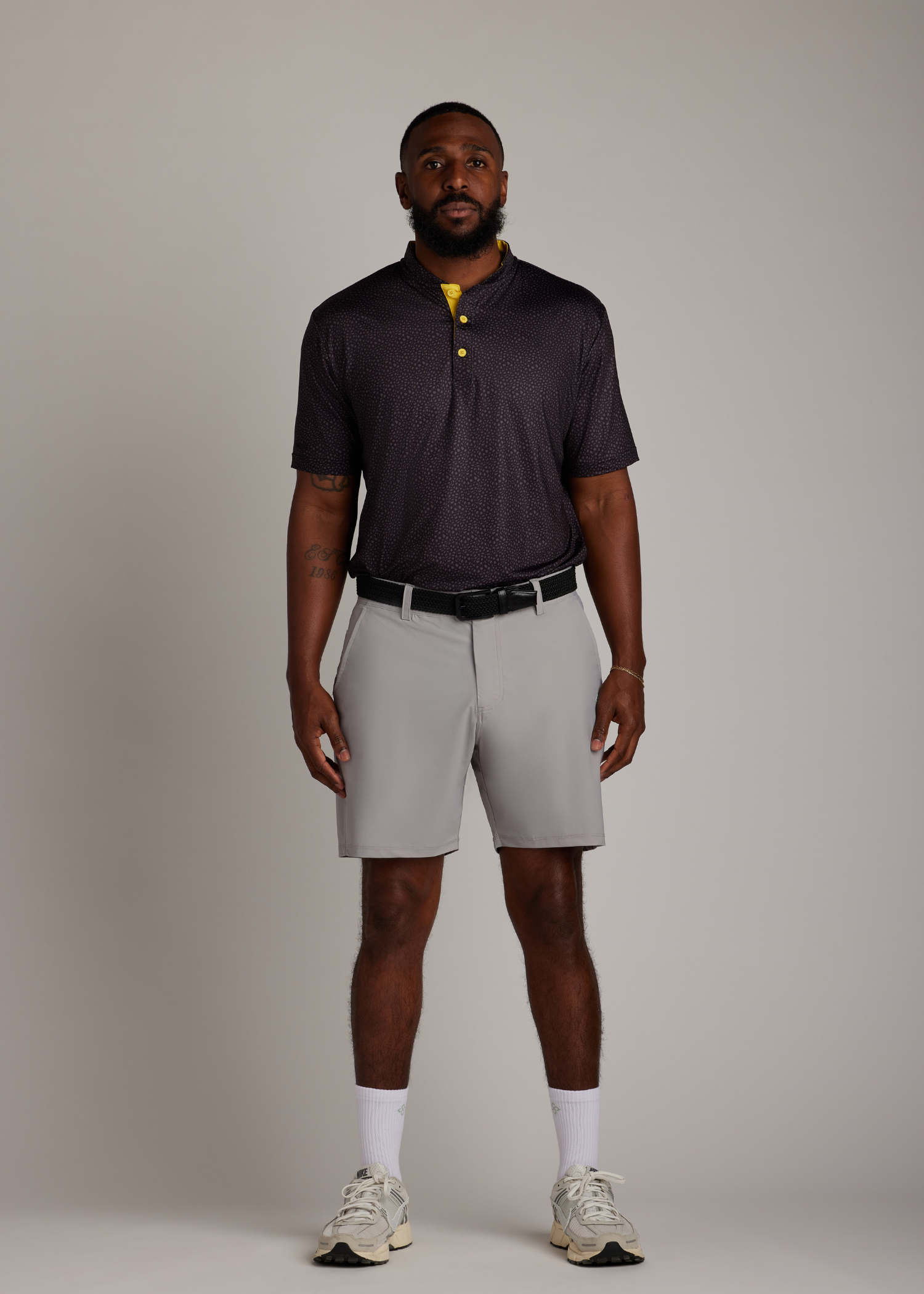 Black knitted belt with a pin buckle, offering durability and flexibility for versatile wear.