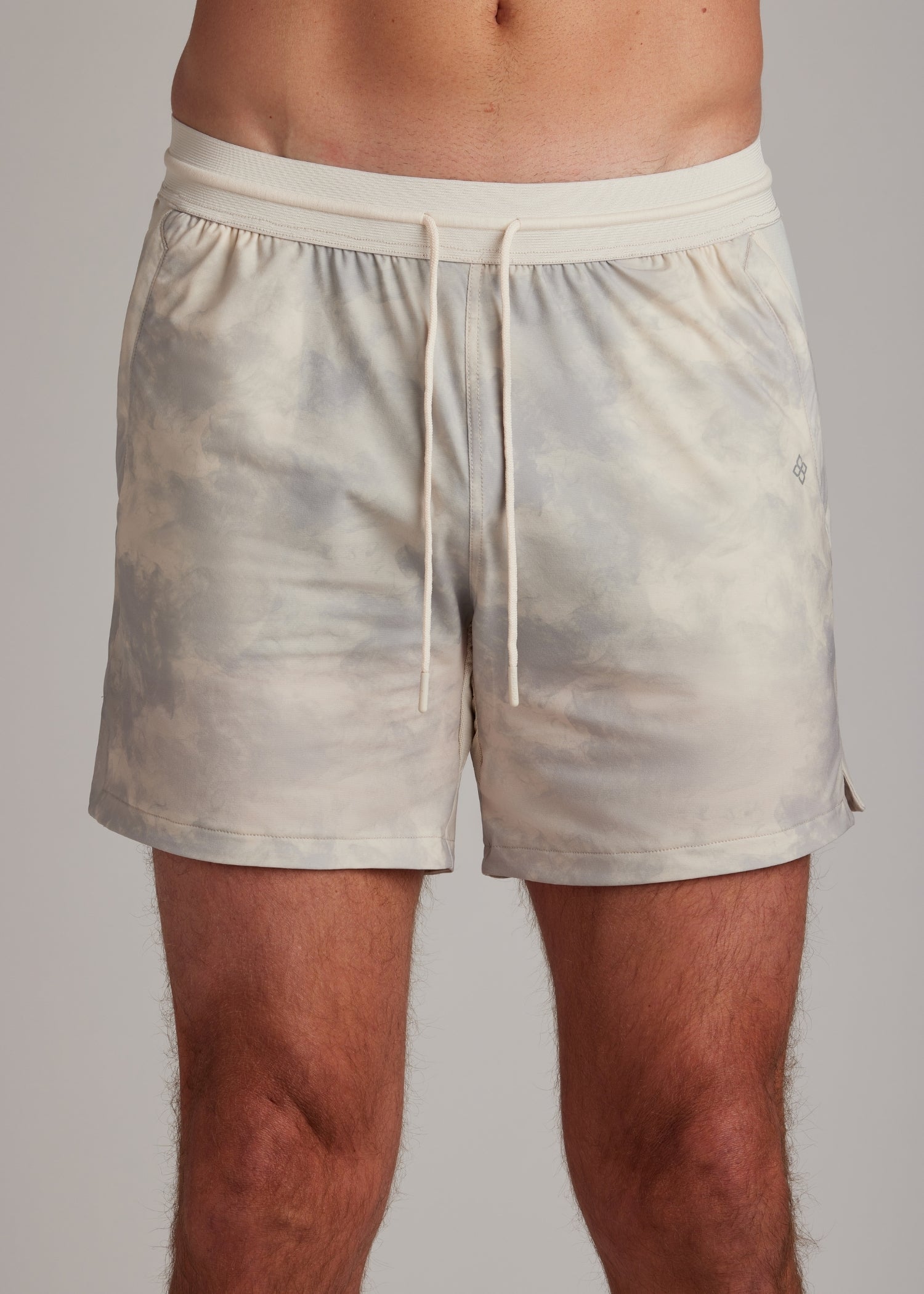 Cream Smoke active shorts featuring an elasticated drawstring waistband for athletic wear.