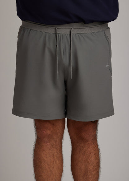 Gray hyper-breathable active shorts with elastic drawstring and zippered pockets for pickleball athleisure.