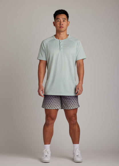 Green 3-button polo tee crafted from breathable micro-mesh, designed for focus and comfort.