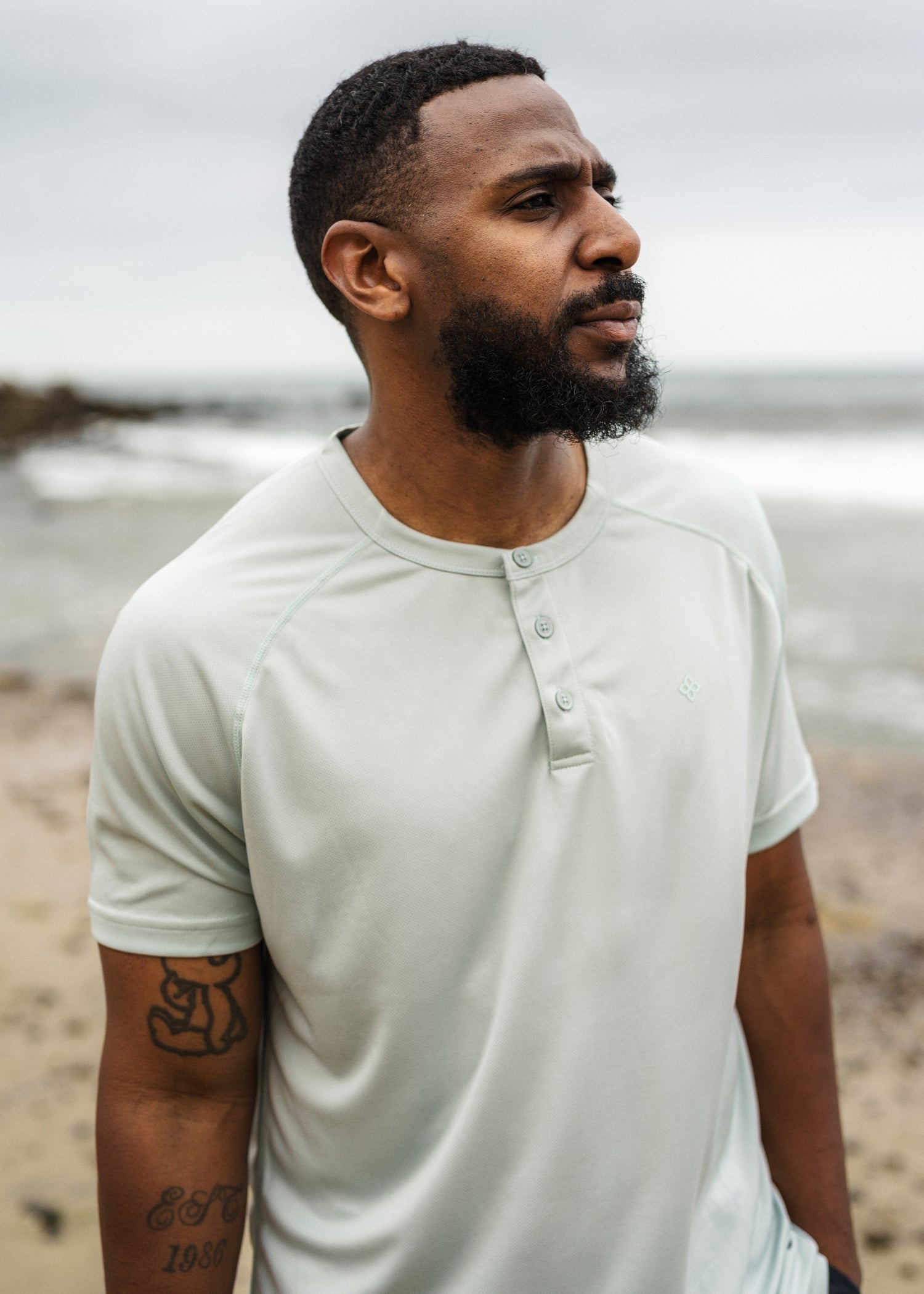 Green 3-button polo tee in breathable micro-mesh fabric, ideal for active game wear.