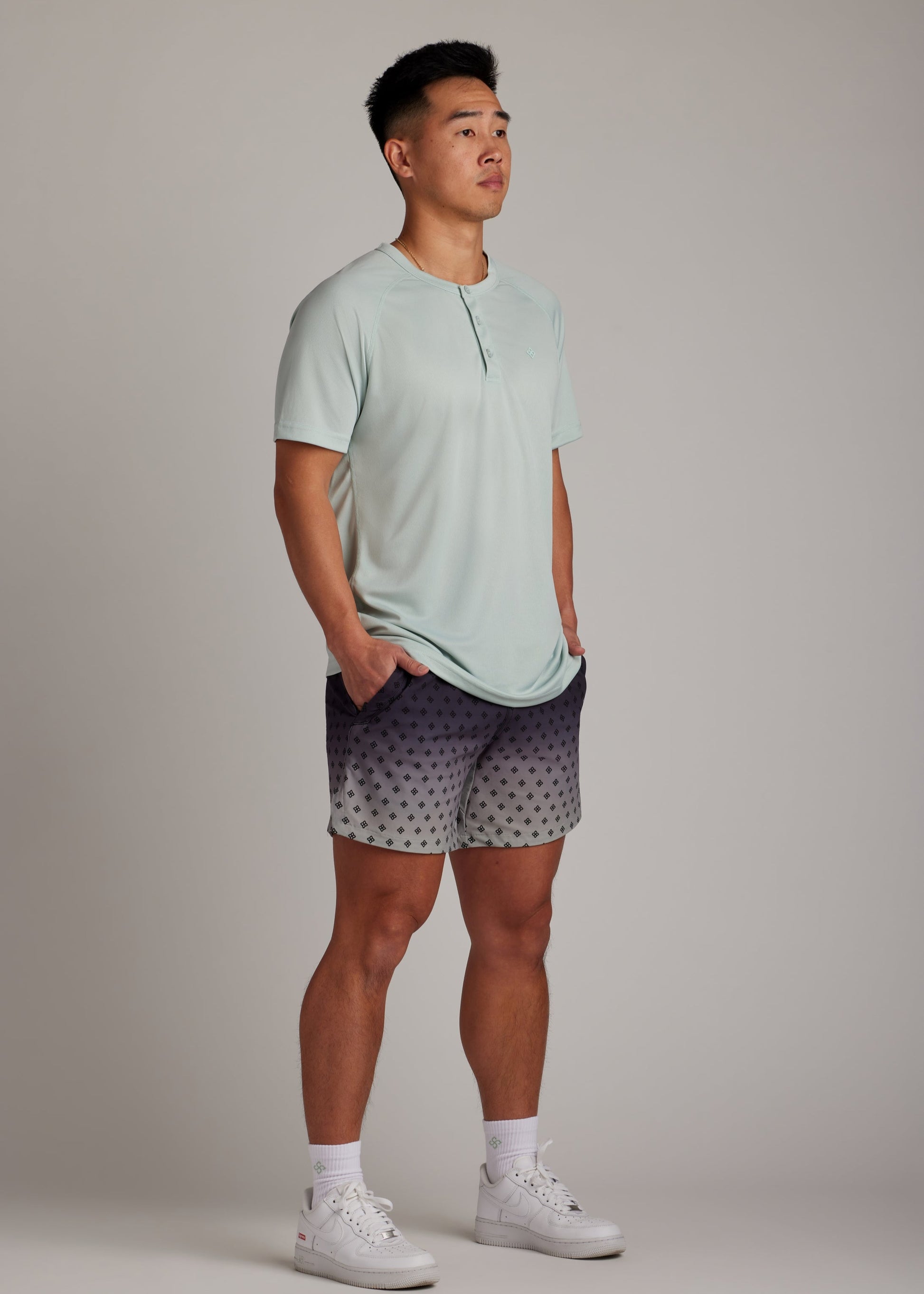 Green 3-button polo tee with modern sport collar, breathable micro-mesh for active wear.