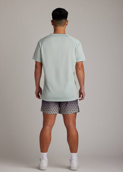 Green 3-button polo tee with modern sport collar, breathable micro-mesh for active wear.