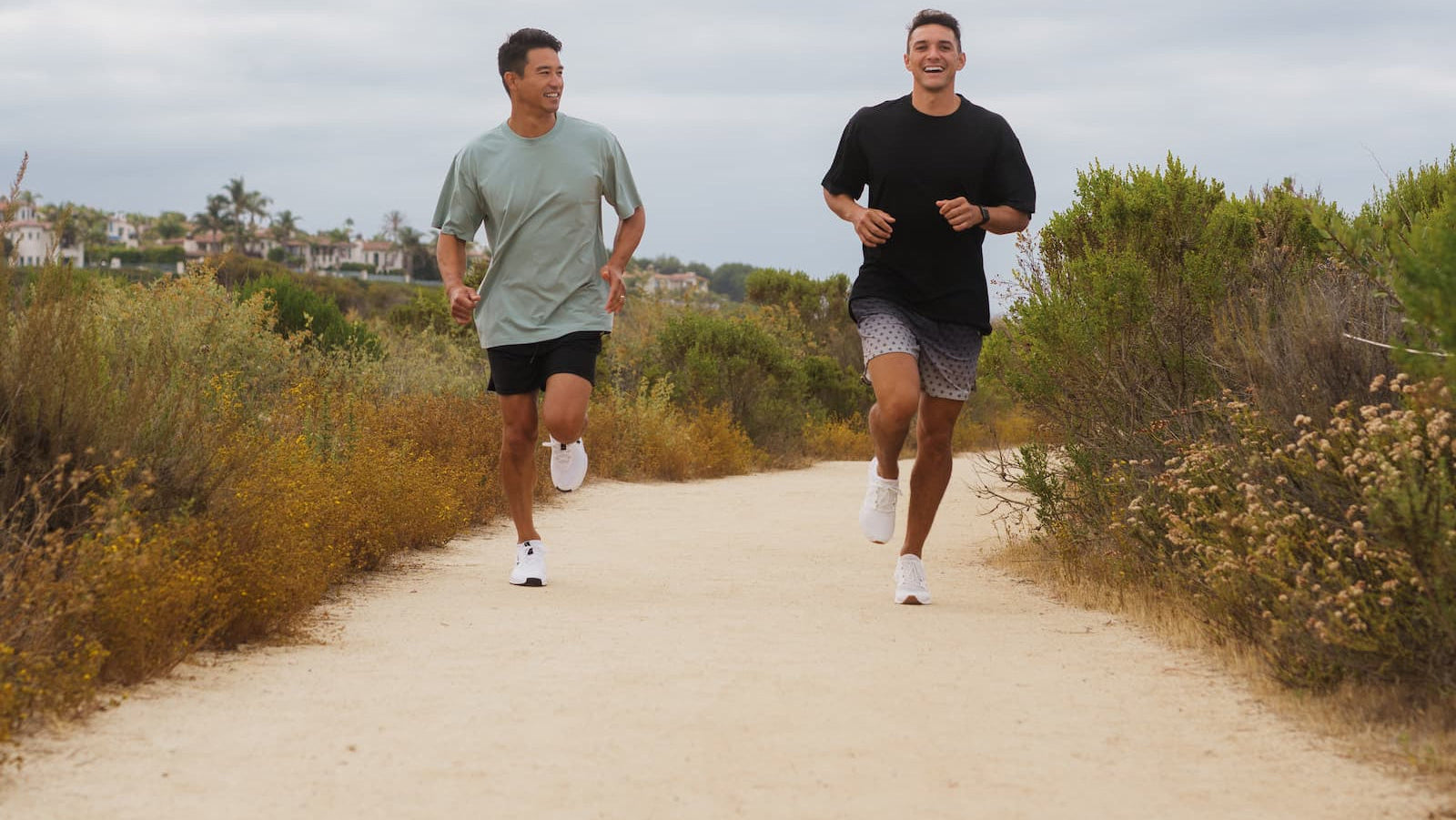 Two men running on a path wearing hasumu shorts and shirts