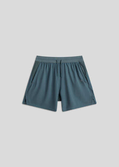 Midnight Emerald active shorts with drawstring waistband and zippered pockets.
