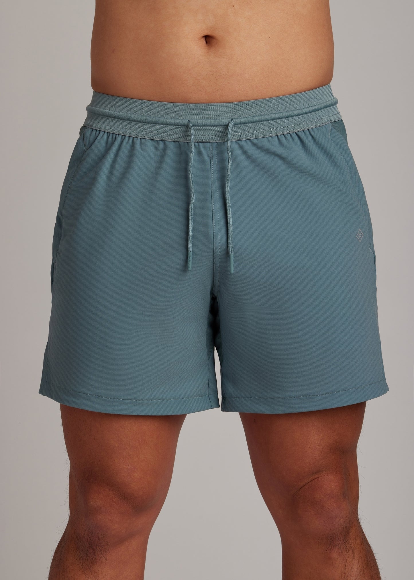 Midnight Emerald active shorts featuring an elasticated drawstring waistband.