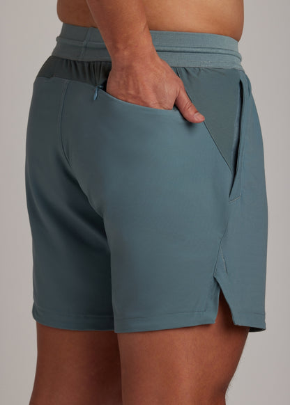 Versatile Midnight Emerald active shorts with mesh-lined zippered front pockets.