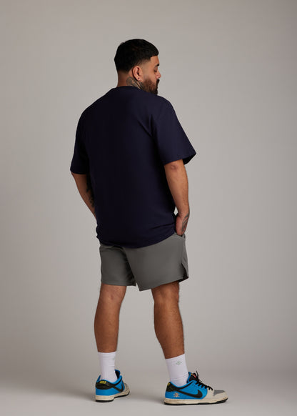 Navy oversized tee in a soft, breathable blend, ideal for post-workout or relaxed days.