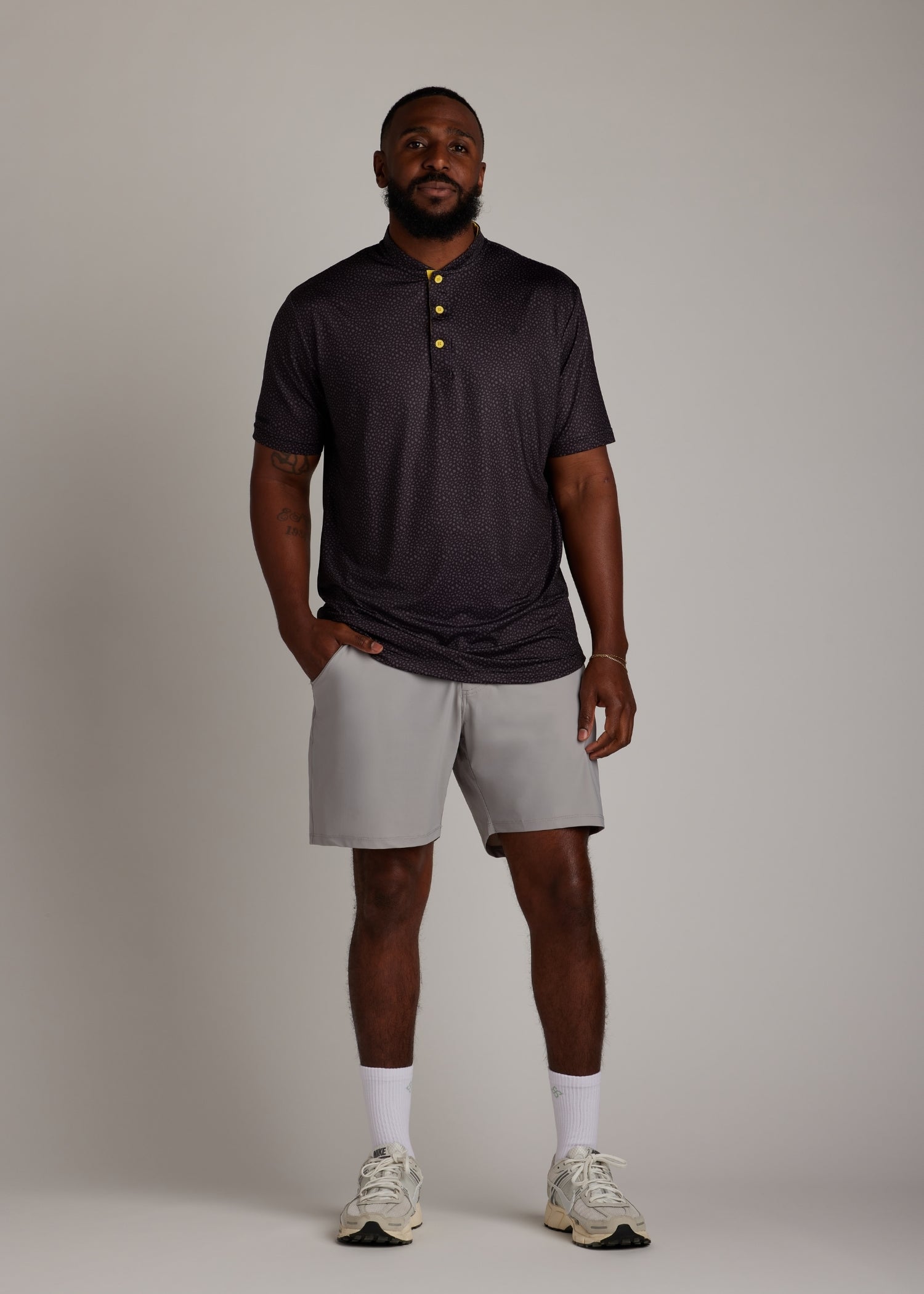 Snake skin pattern bladed collar polo shirt in performance fabric for modern athletic style.