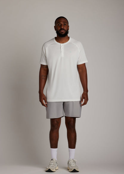 White 3-button polo shirt, breathable micro-mesh fabric, modern sport collar for golf.