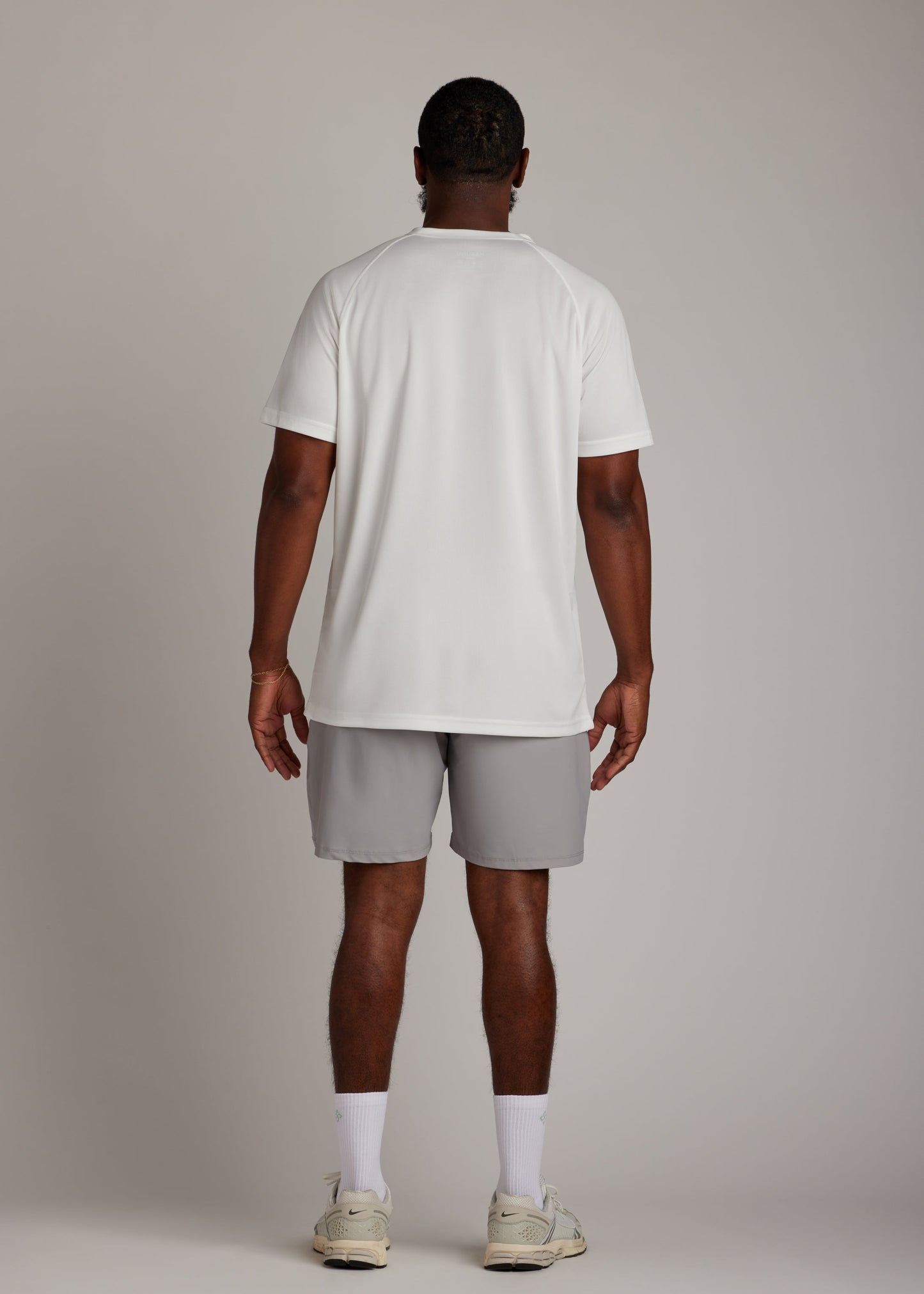 White 3-button polo shirt, breathable micro-mesh fabric, modern sport collar for golf.