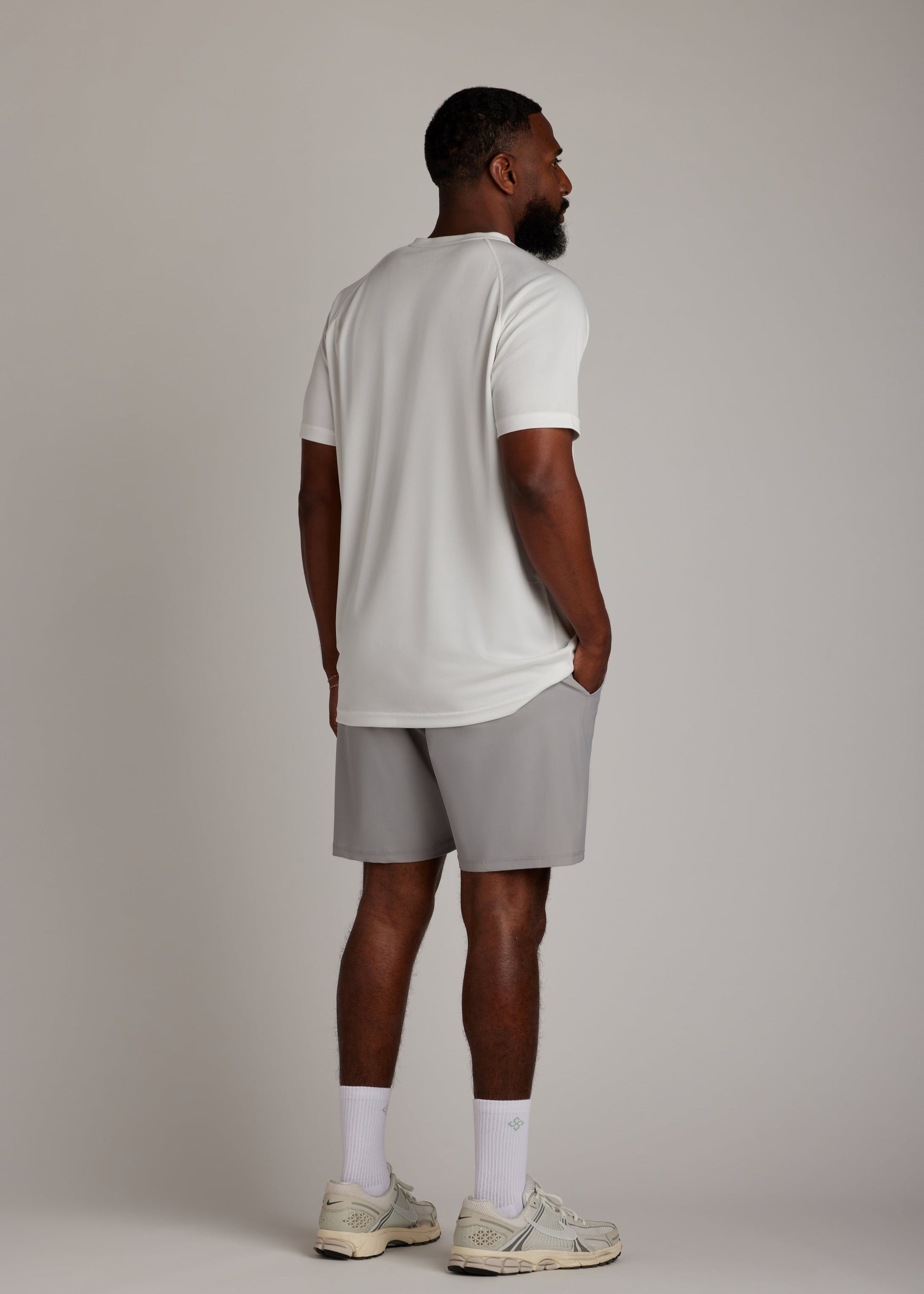 White 3-button polo shirt, breathable micro-mesh fabric, modern sport collar for golf.